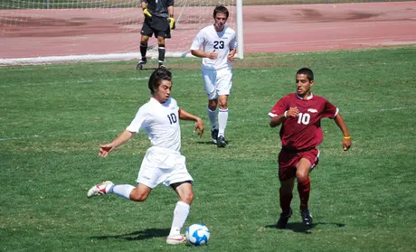 Photo: Previous CSUMB soccer player Kyle Satow about to kick a soccer ball while playing against another team