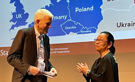 Former Ukranian Ambassador Steven Pifer, left, speaks with Shigeko Sekine after addressing students.