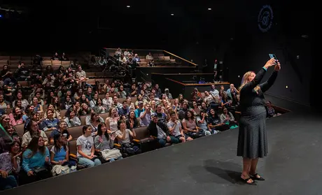 President Vanya Quinones takes a selfie with first-year students