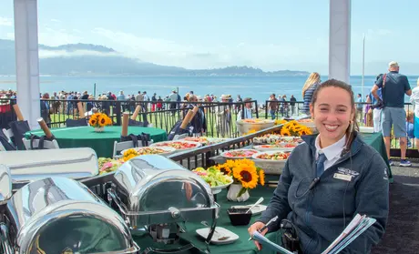 Intern Joanna Rivera-Arce manages a guest area at the 2023 Concours d'Elegance