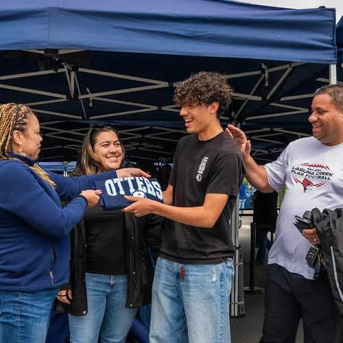 New student being welcomed to campus with CSUMB apparel.