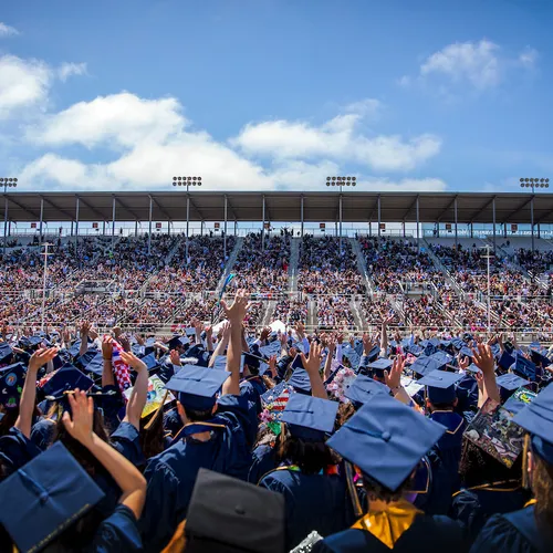 Graduates celebrate together at commencement, marking a milestone moment in a vibrant and supportive campus community.