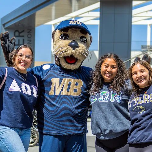 Three students and a mascot