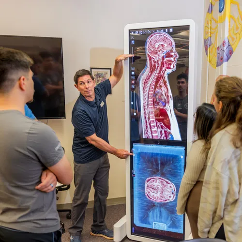 Professor showing students a presentation in class.