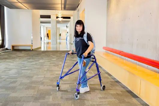 Student using a mobility walker