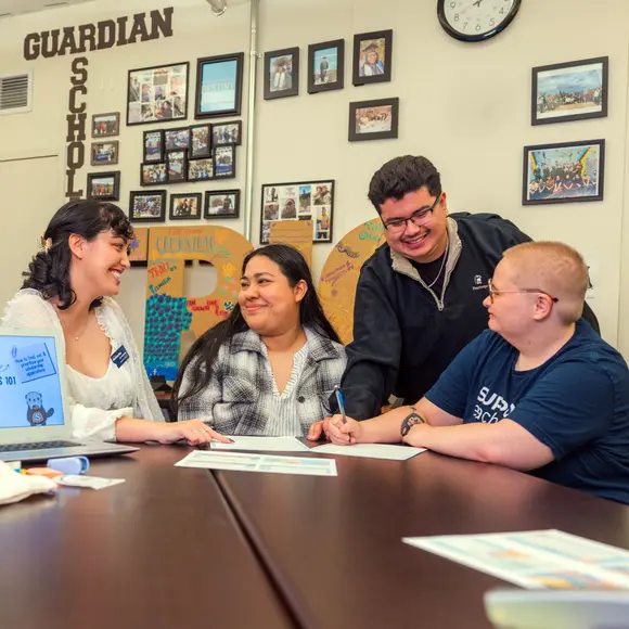 A group of people talking to each other.