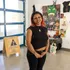 Student standing and smiling for a portrait in an art gallery.