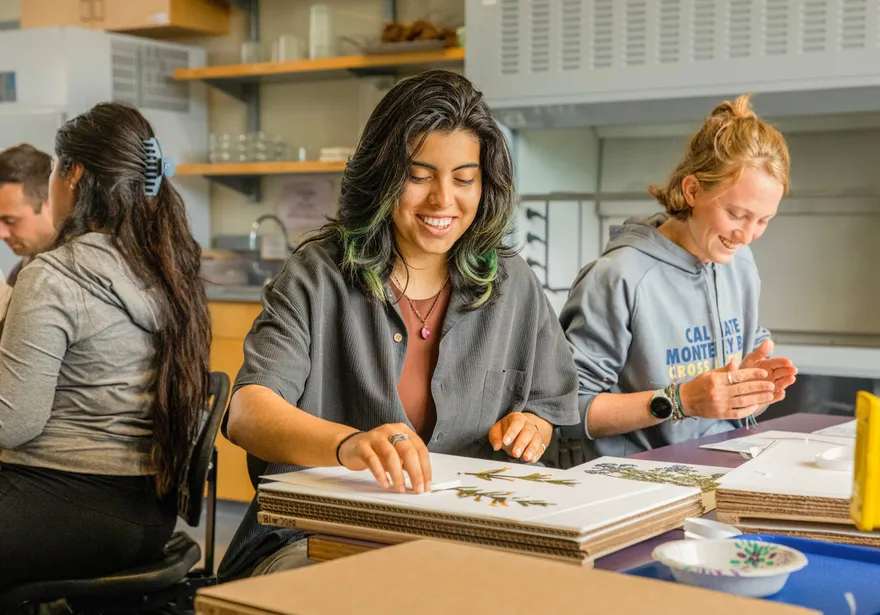 Students smiling doing crafts