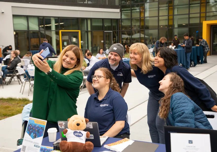 President Vanya Quiñones taking a selfie with staff members at Otter Thursday.