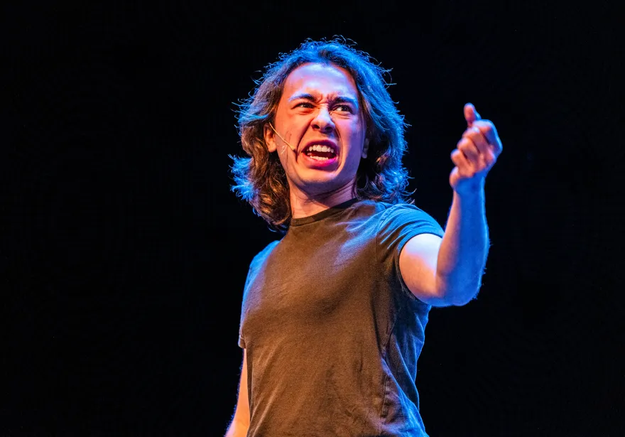 Student singing on a stage