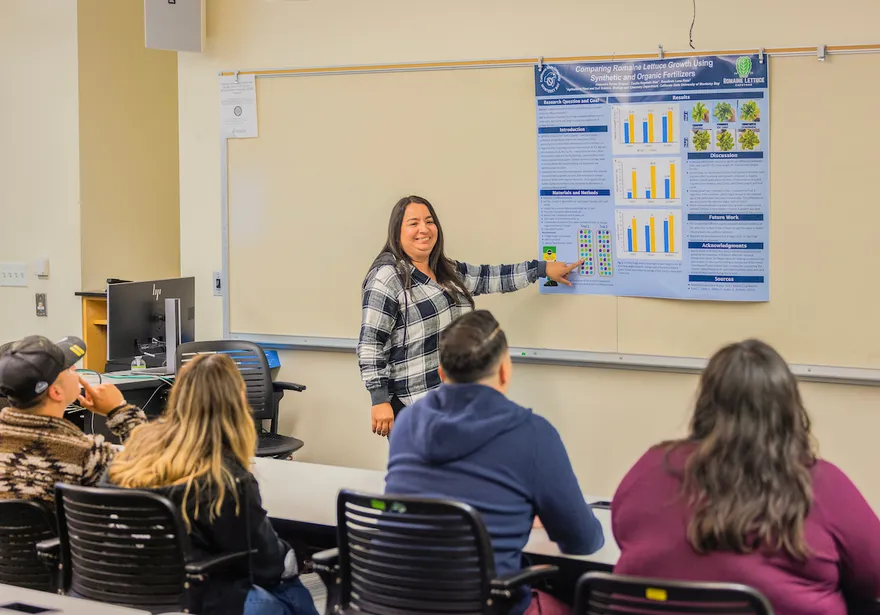 A student presents research findings to classmates, fostering an interactive and collaborative learning environment.