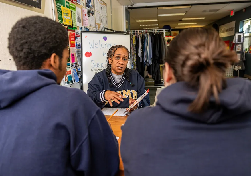 People talking together around a table in a classroom environment