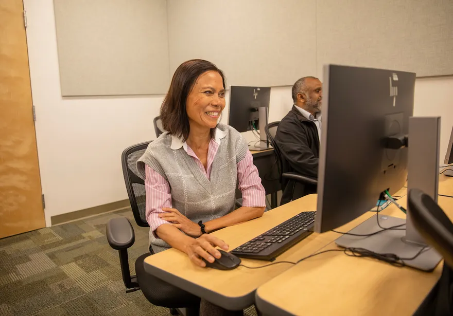 Finance team members sitting at a desk in a office enviroment