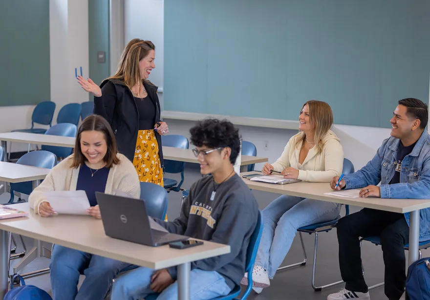 A faculty member engages students in a classroom discussion, creating an interactive and supportive learning environment.