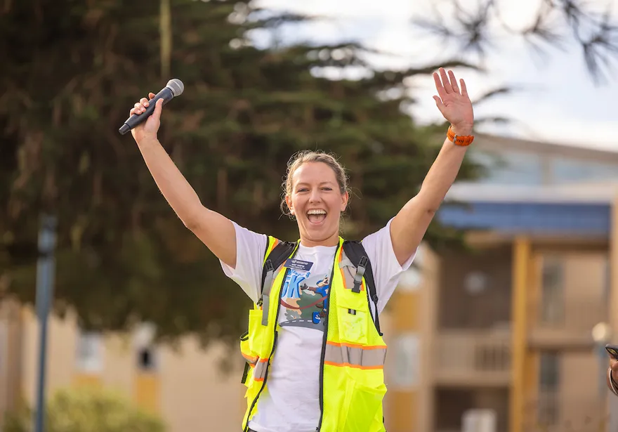 Student celebrates outdoors during a campus event, highlighting school spirit and community engagement.