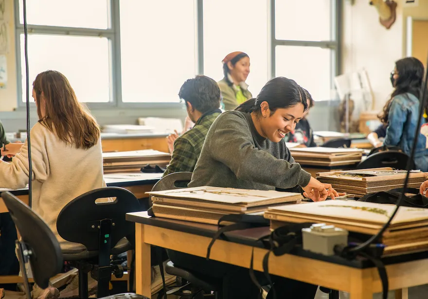 Students in a classroom working with art