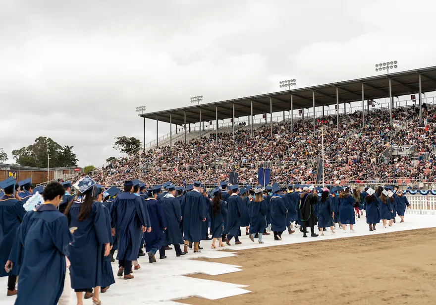 ���ӽ紫ý graduates walking to their seats during the commencement event