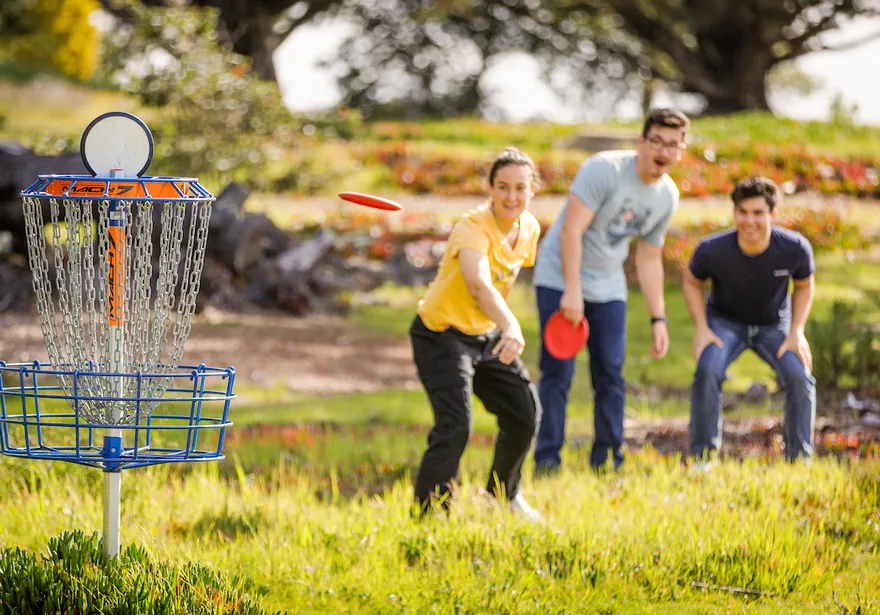 Students playing frisbee golf