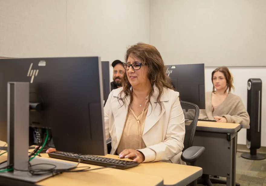 A group of finance faculty members on computers