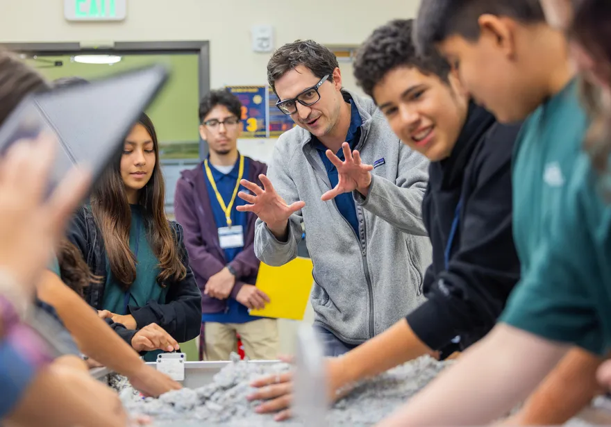 Teacher speaking to students about an experiment