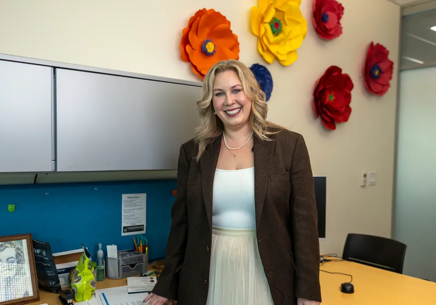 A business administration professor smiling at the camera