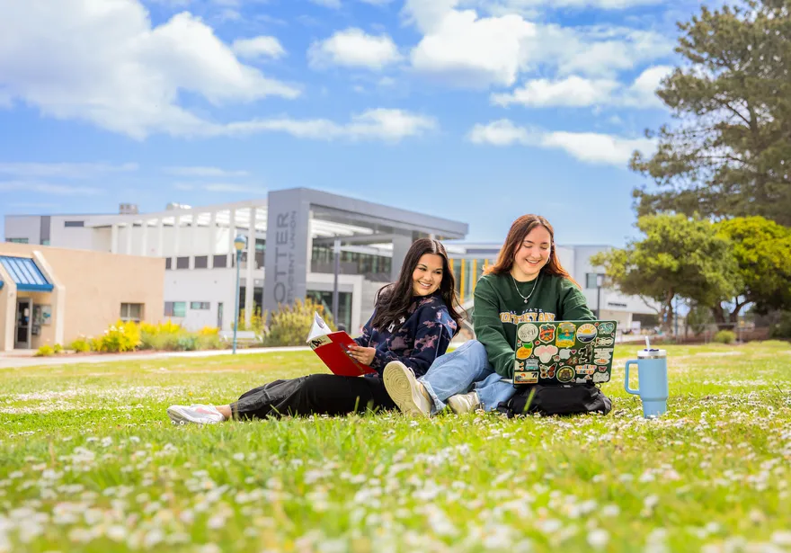 Two female students studying at the campus quad