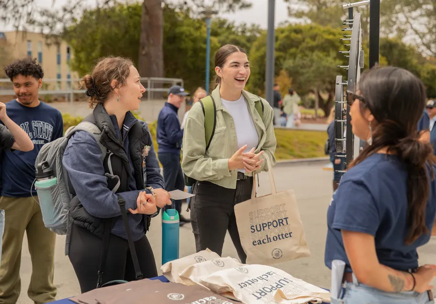 Students chatting at a stand outdoors