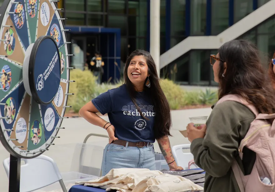 Two people looking at a wheel of fortune